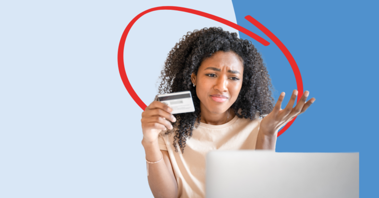 a young women looking at her laptop with concern, after noticing credit card fraud on her account