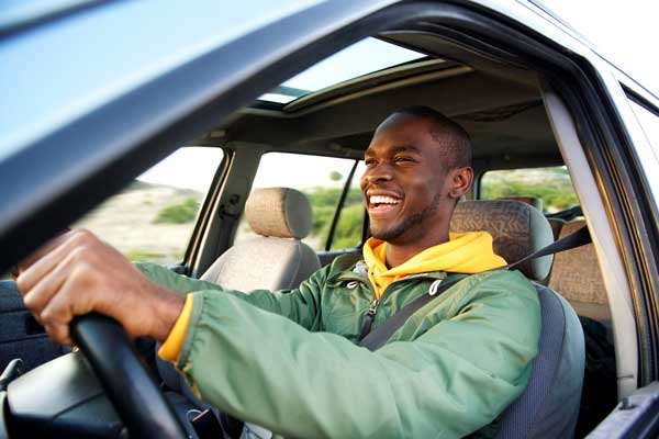 man driving a car while smiling